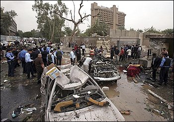 Iraqis gather at the site of a massive bomb attack in Baghdad, Iraq, Sunday, Oct. 25, 2009. Iraq police say that a pair of powerful explosions went off near the Ministry of Justice and the offices of a Kurdish political party during the morning rush hour as people headed to work. (AP Photo/Khalid Mohammed)