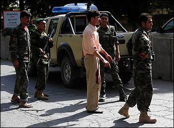  A man in blood soaked clothing stands near the site where a car bomb exploded outside NATO headquarters in Kabul, Afghanistan.