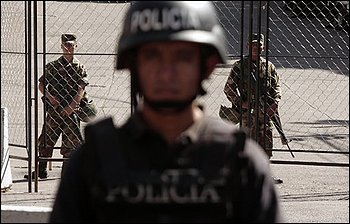 Police officers and army soldiers stand guard in a street near the Brazilian embassy in Tegucigalpa, Wednesday, Oct. 28, 2009. Thomas Shannon, U.S Assistant Secretary of State for Western Hemisphere Affairs, arrived in Honduras Wednesday trying to revive talks with Honduras' ousted President Manuel Zelaya on how to solve the political crisis in the country. (AP Photo/Arnulfo Franco)