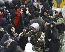 Police officers try to quell an anti-government march in Tehran on the sidelines of state-sanctioned rallies to mark the embassy takeover.