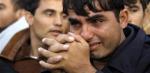 An illegal Afghan migrant cries as police evacuate him and others at an improvised camp in Calais, northern France, Tuesday September 22, 2009. French police began clearing on Tuesday an improvised camp dubbed "the jungle" where illegal migrants, mostly Afghans, gather near the port of Calais before trying to cross to Britain.  REUTERS/Pascal Rossignol  